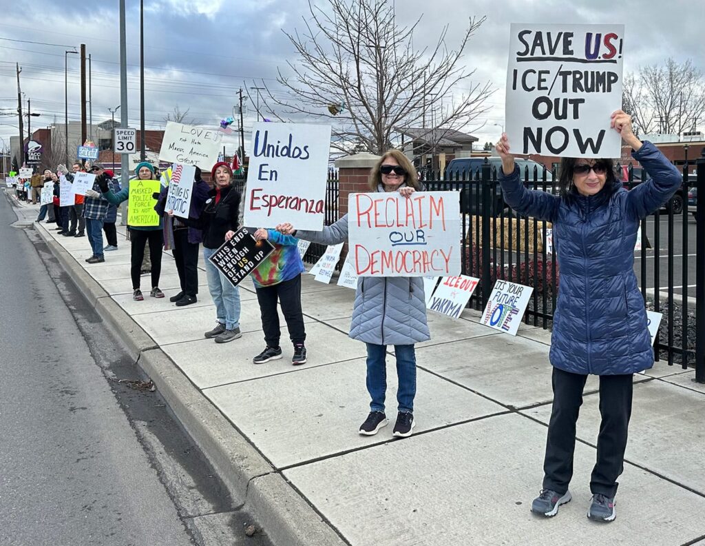 Protesters holding signs at Justice for ALL protest